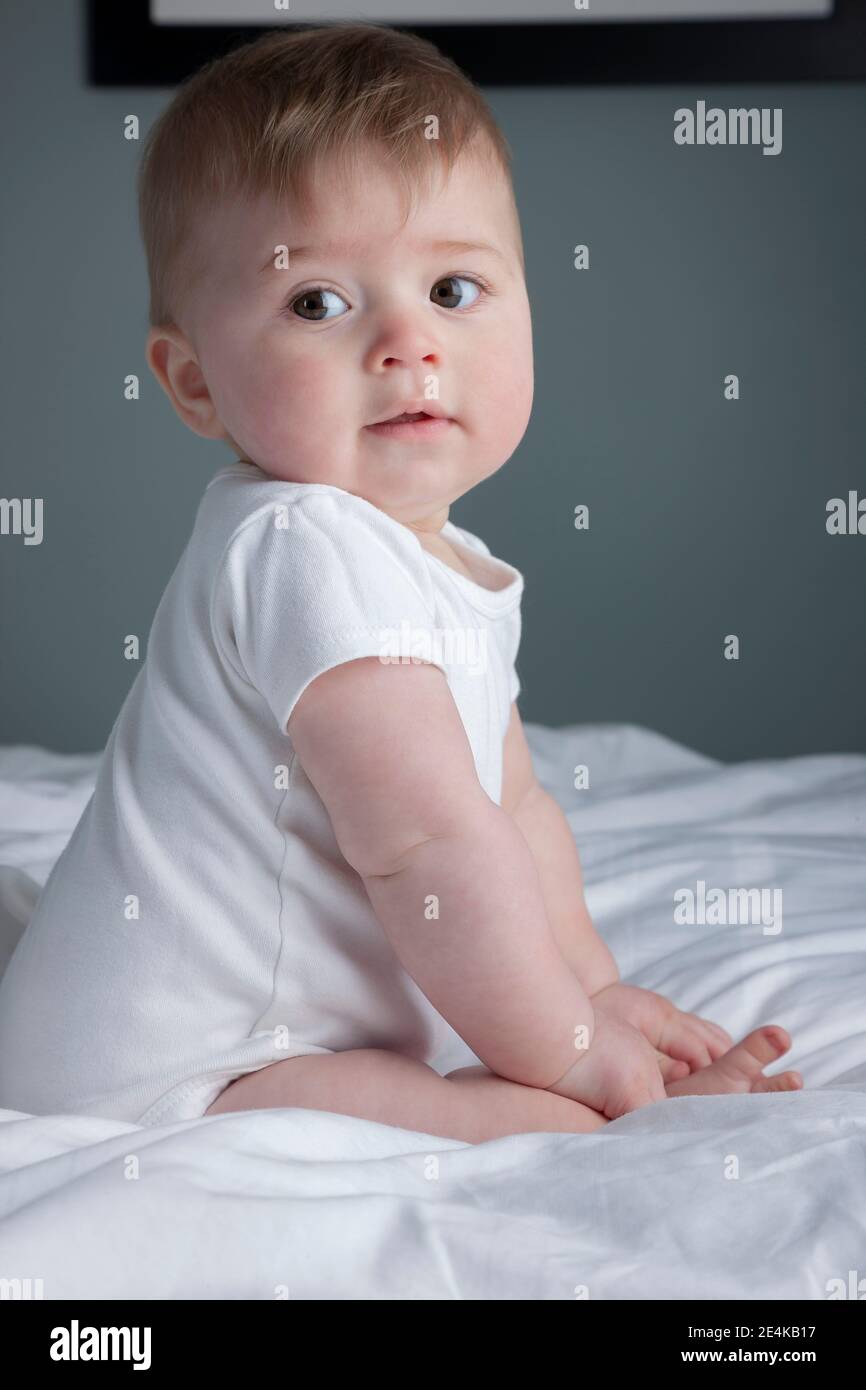 Baby boy lying on bed Stock Photo Alamy