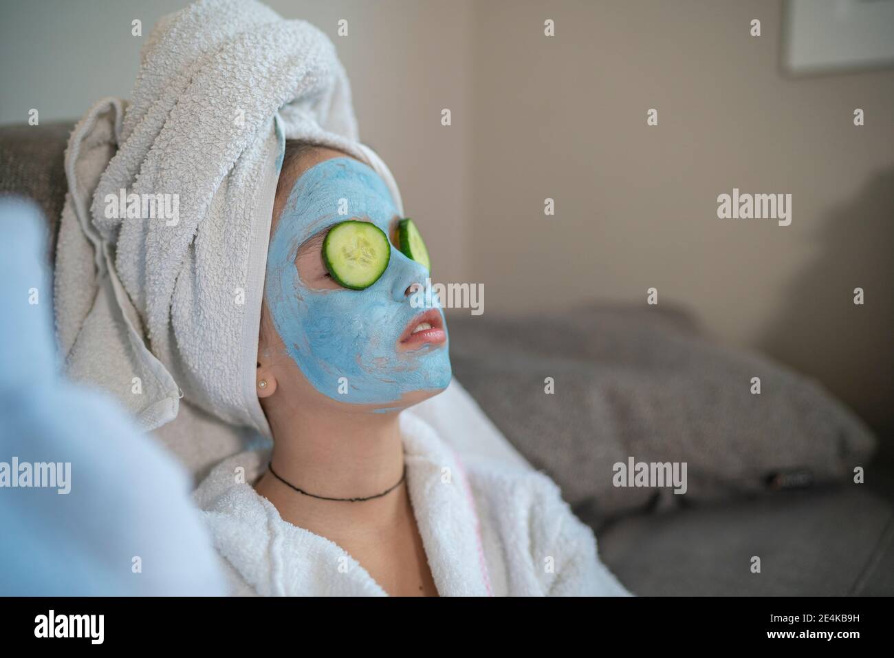 Girl with facial mask and cucumber slice on face Stock Photo