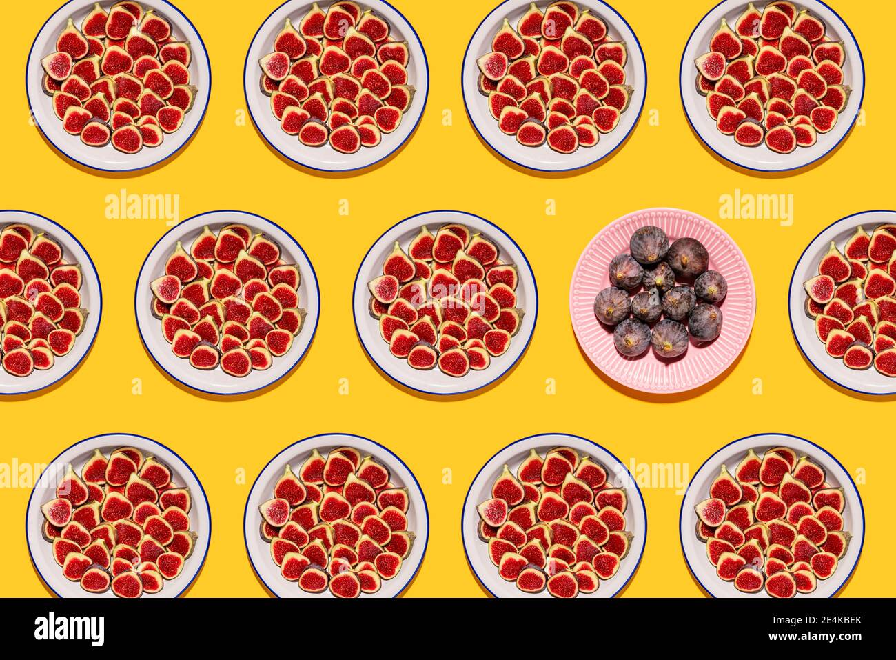 Pattern of plates with fresh halved figs Stock Photo