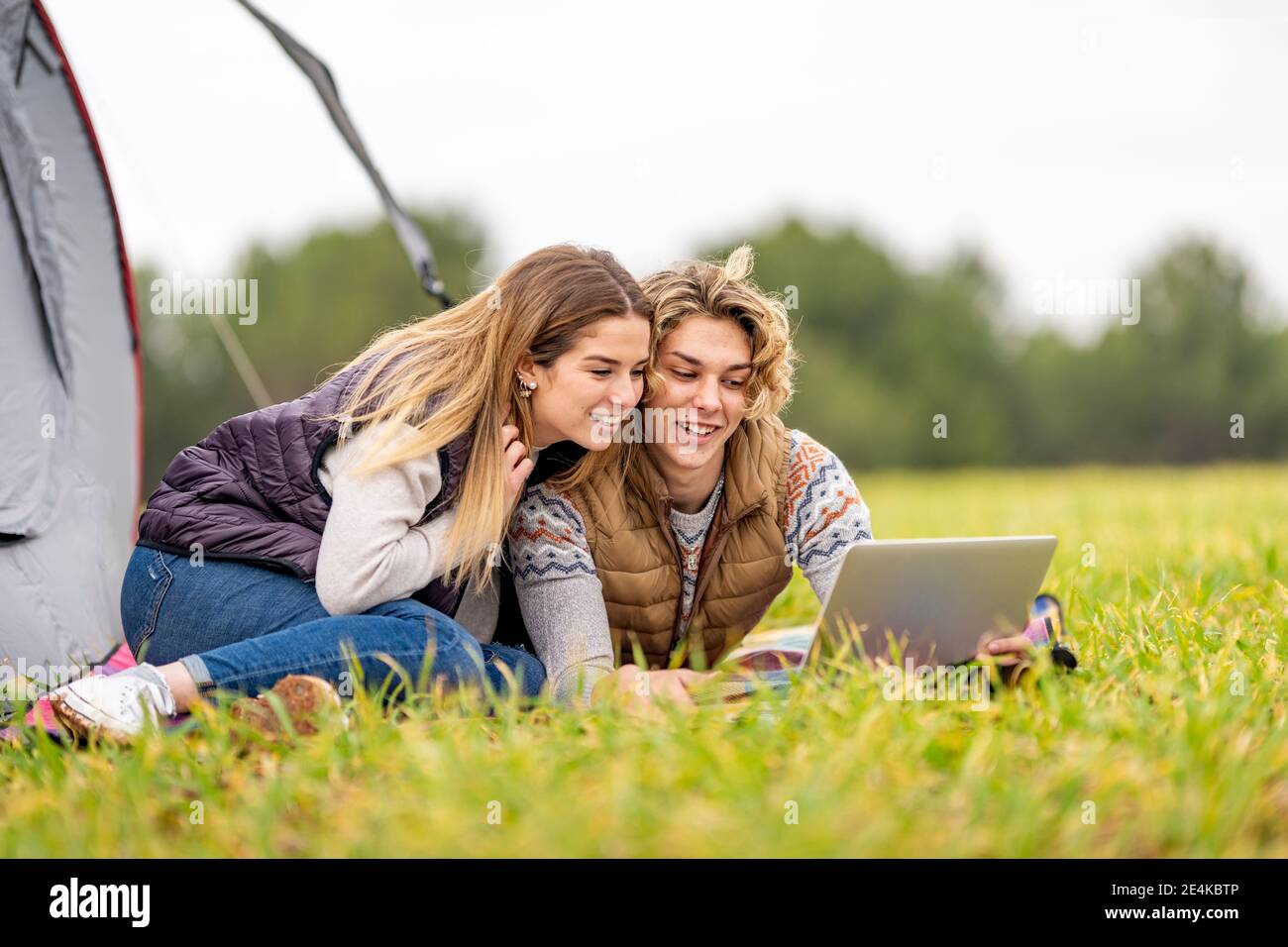 Brother and sister lying together on grass with digital tablet Stock ...
