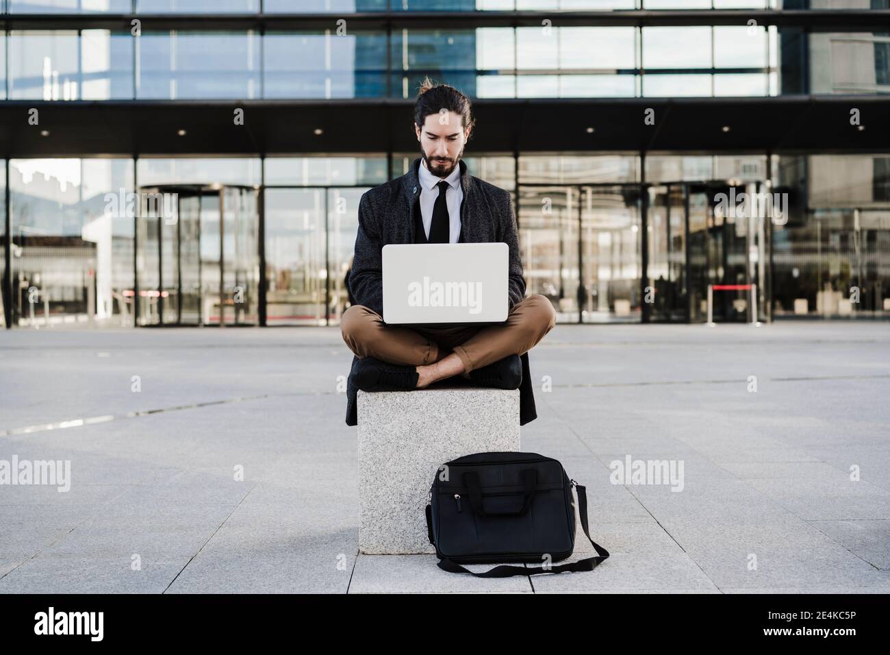 Sitting cross legged on bench hi-res stock photography and images - Alamy