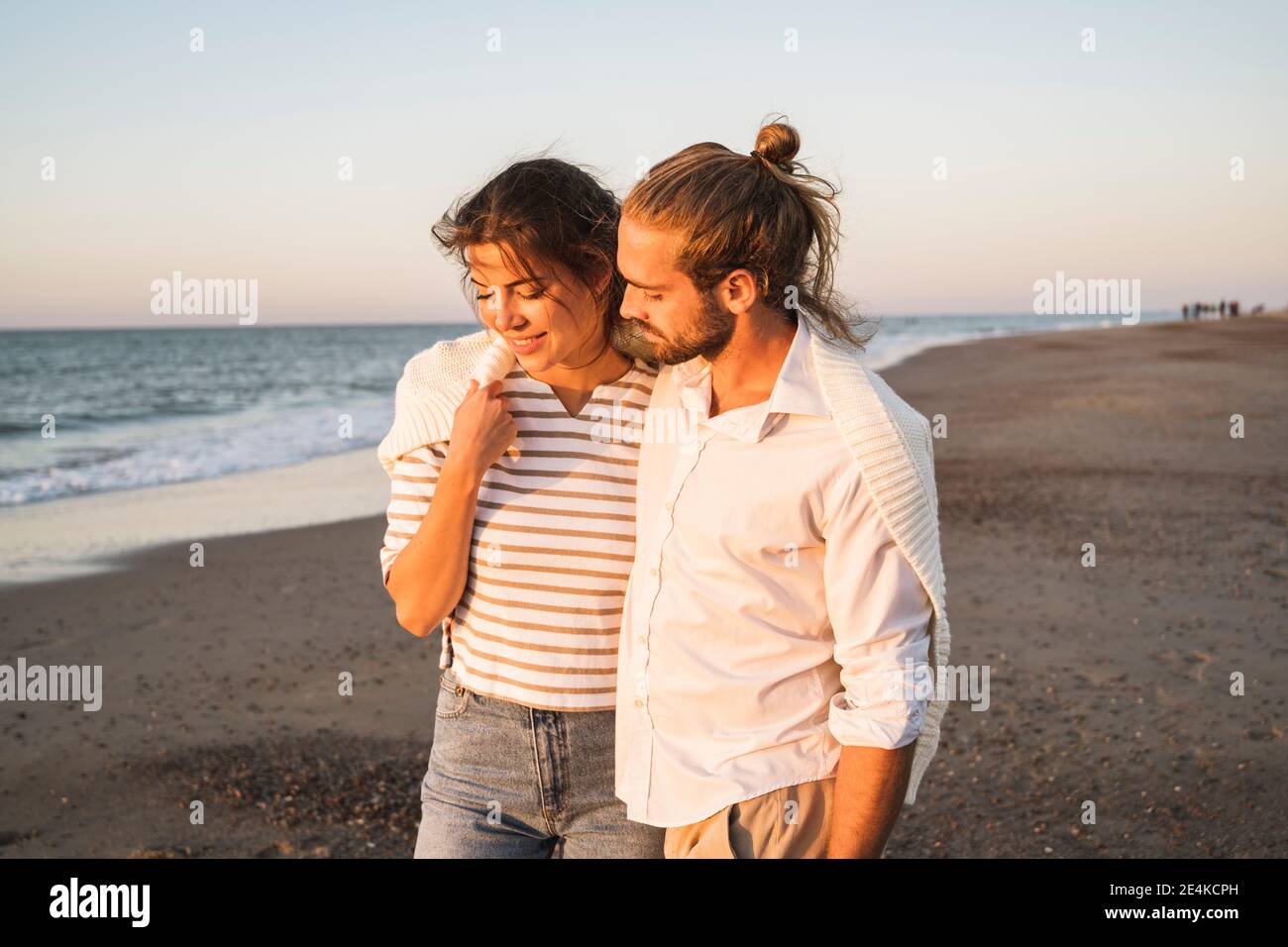 Romantic young couple walking at beach during vacation Stock Photo