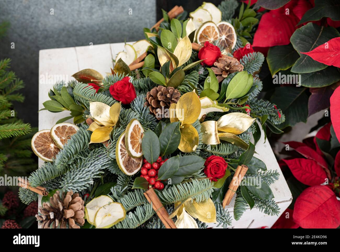 Christmas decoration with flowers and orange slices in flower shop Stock Photo