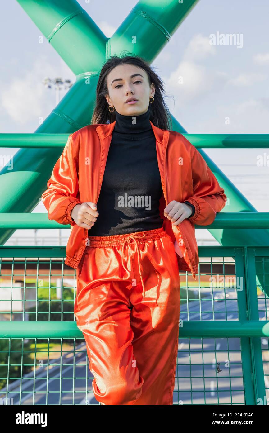 Confident young woman standing on bridge Stock Photo