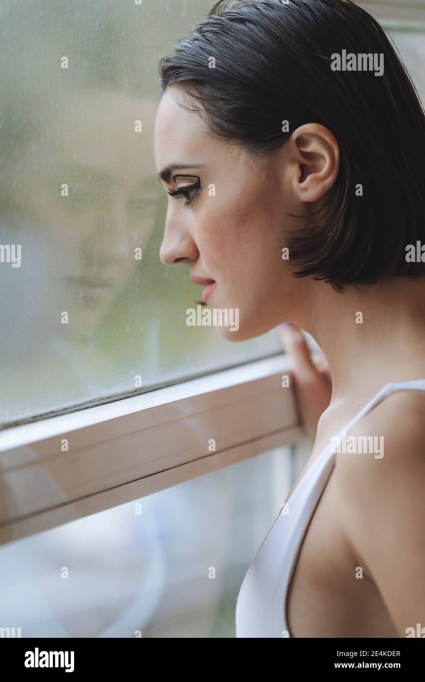Close-up of thoughtful young woman looking through window in ballet studio Stock Photo