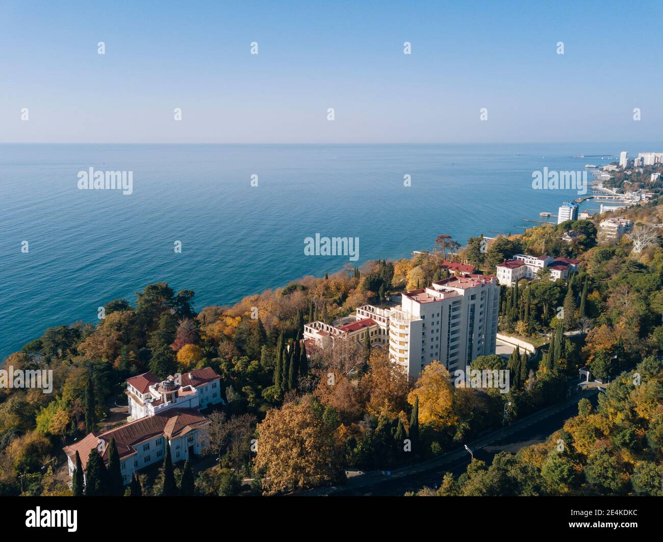 Russia, Krasnodar Krai, Sochi, Aerial view of edge of coastal city in autumn with clear line of horizon over Black Sea in background Stock Photo