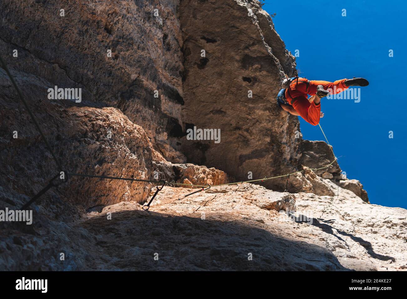 Active male athlete climbing rocky mountain Stock Photo