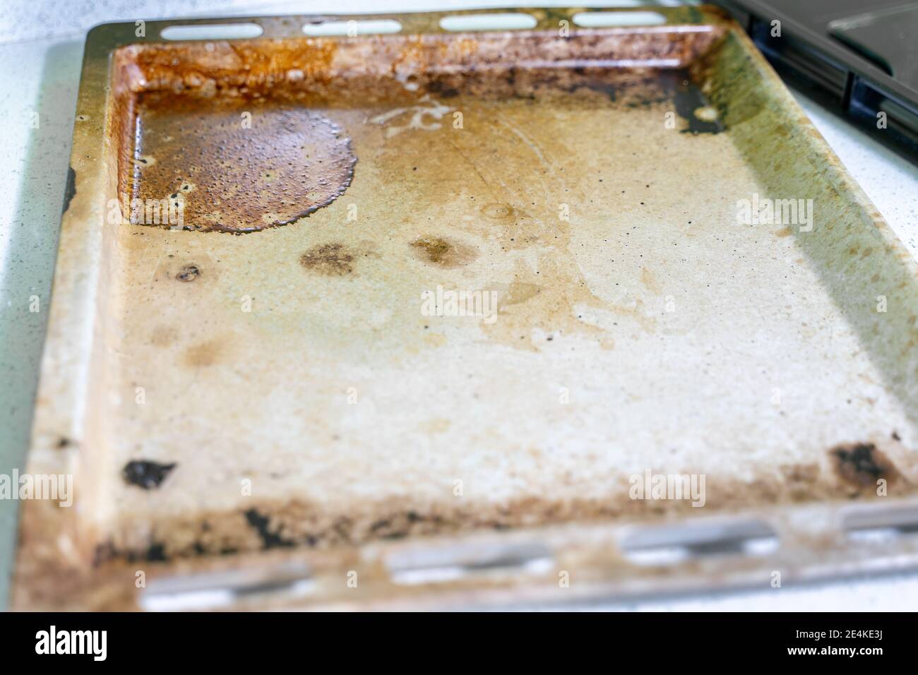 very dirty baking tray covered with grease and stains Stock Photo Alamy