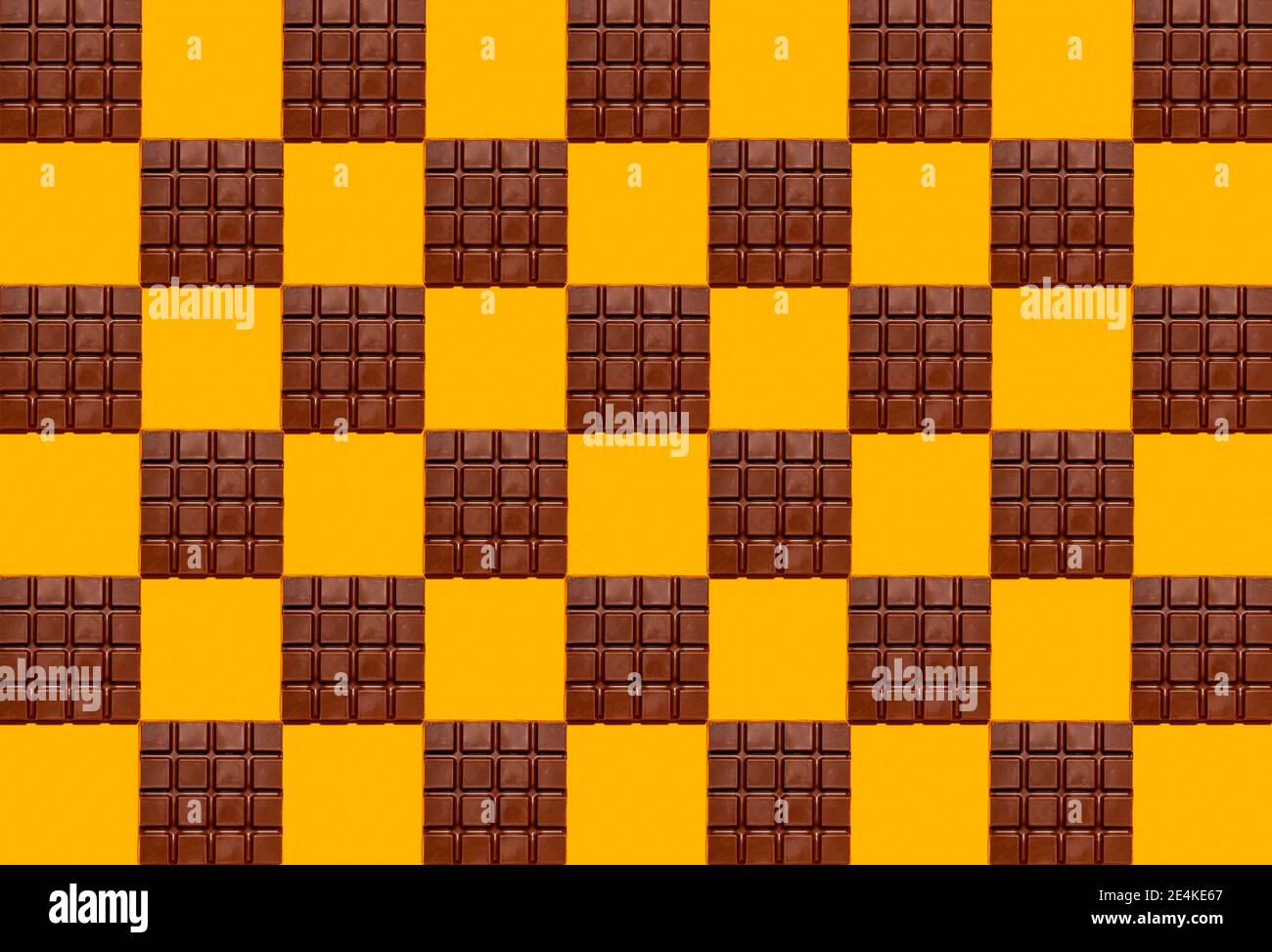 Pattern of chocolate bars against yellow background Stock Photo