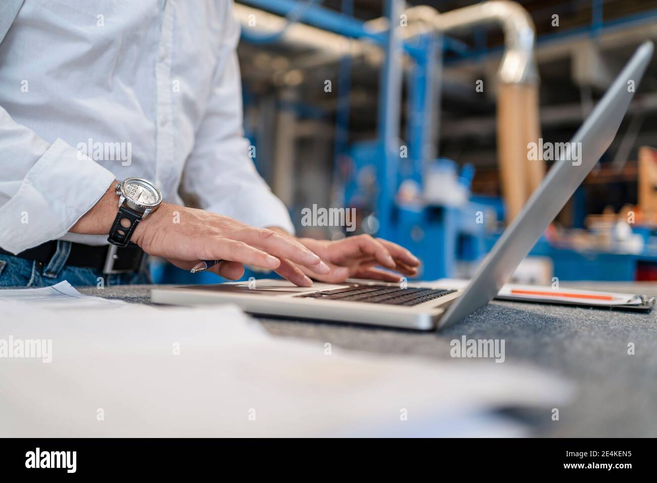 Hands of man typing on laptop Stock Photo