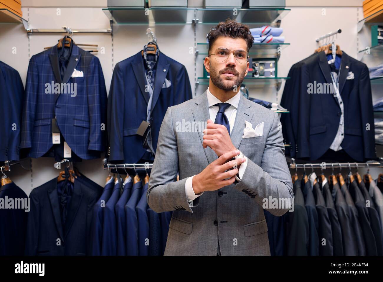 Portrait of man in gray suit in tailors boutique Stock Photo
