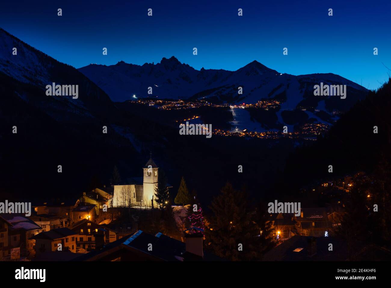 Night panorama of Champagny-en-Vanoise over Courchevel valley and ski resort with Alps mountain peaks view from Stock Photo
