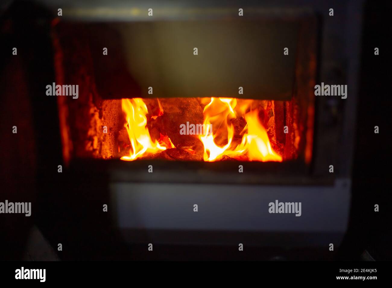 fuel-stove-with-burning-coals-heating-the-house-in-winter-stock-photo