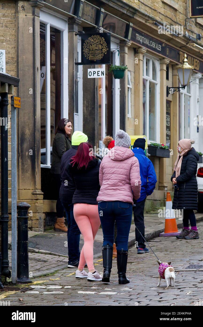Honley, Huddersfield, Yorkshire, UK, 24 January 2021. Queueing for
