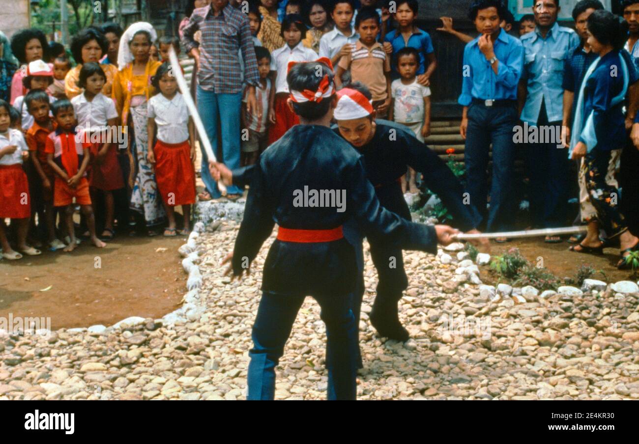 Kerinci Sumatra Indonesia Pencak Silat Martial Art Opponents fighting with Broadswords Stock Photo