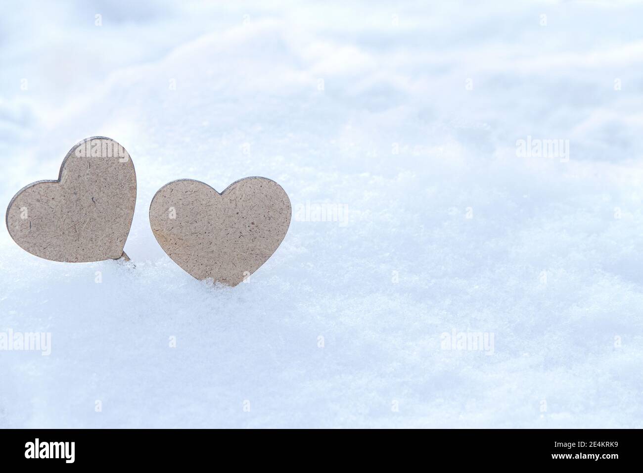Couple hearts on snow background. St. Valentine's Day background. Stock Photo