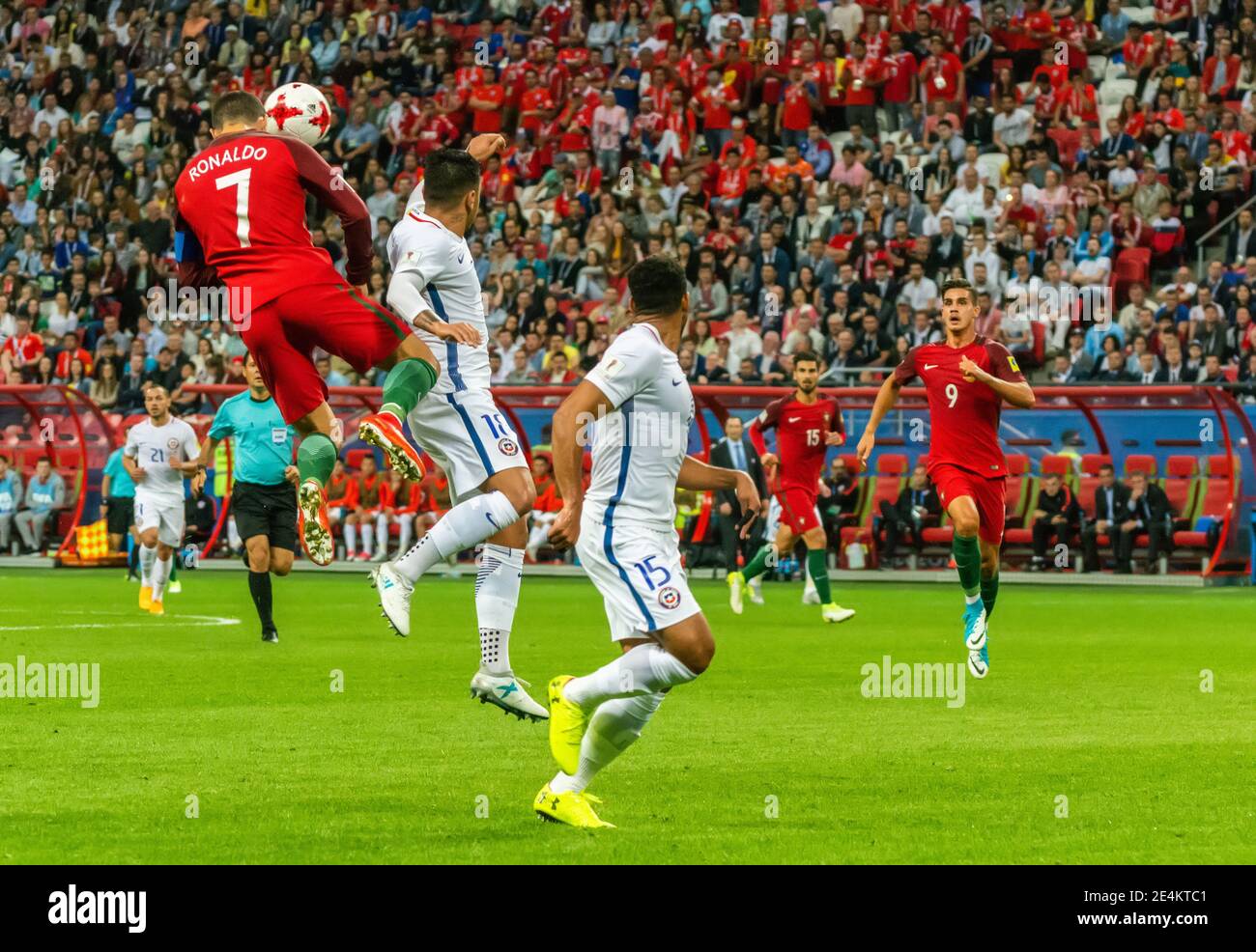 Kazan, Russia – June 28, 2017. Portugal national football team captain Cristiano Ronaldo performing a header in aerial with Chile players Gonzalo Jara Stock Photo