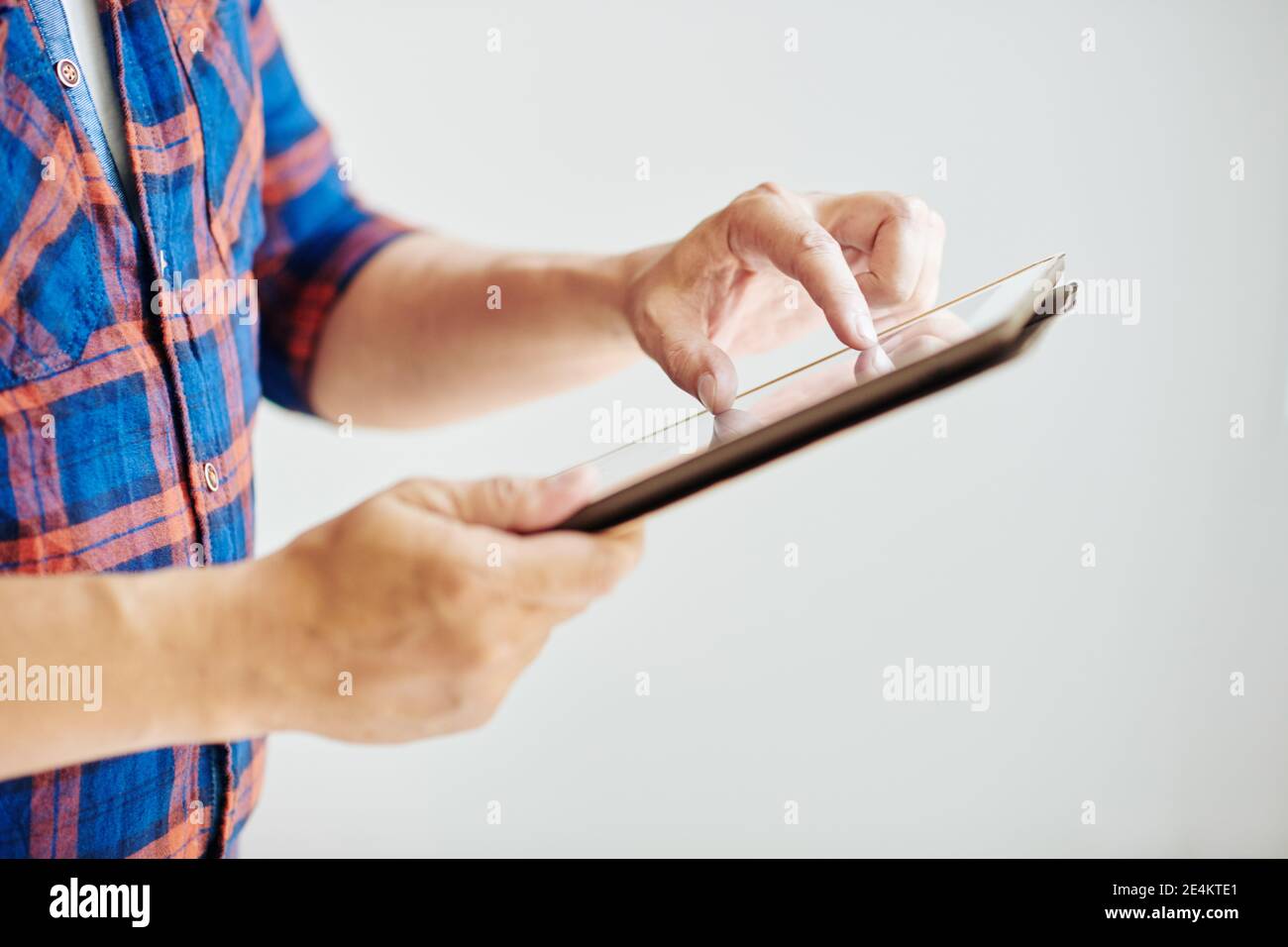Man zooming image on tablet Stock Photo