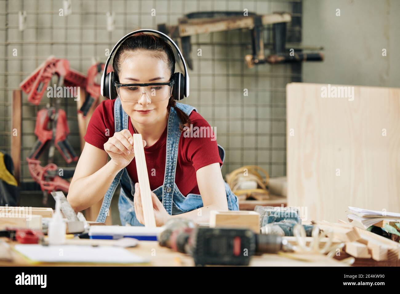 Carpenter checking plank evenness Stock Photo