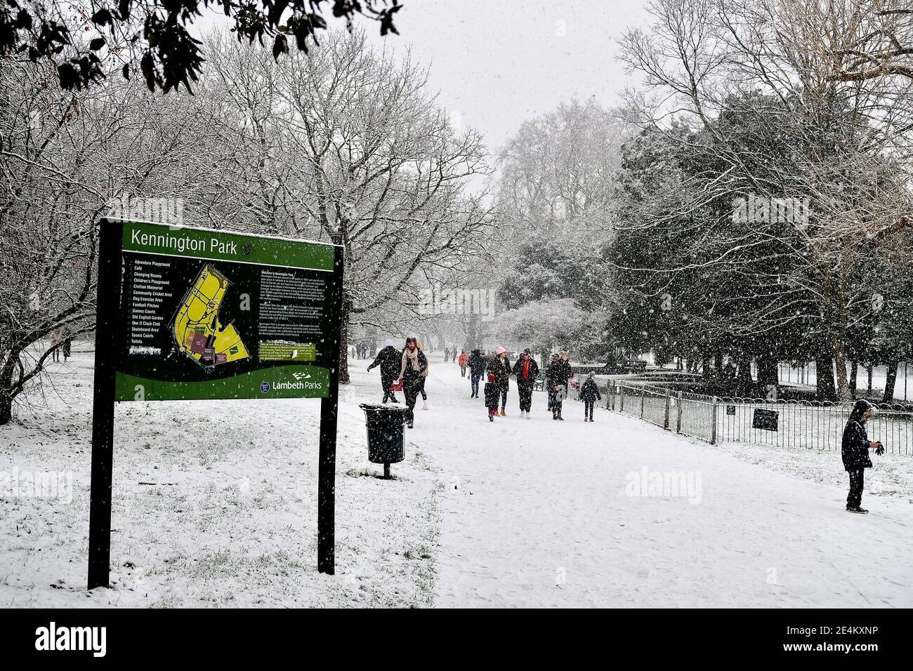 Kennington Park, London, UK. 24th January 2021. People walking in Kennington Park (near south entrance)  at the during heavy snow fall in London, UK. Credit: Harrison Hodgkins/Alamy Live News. Stock Photo