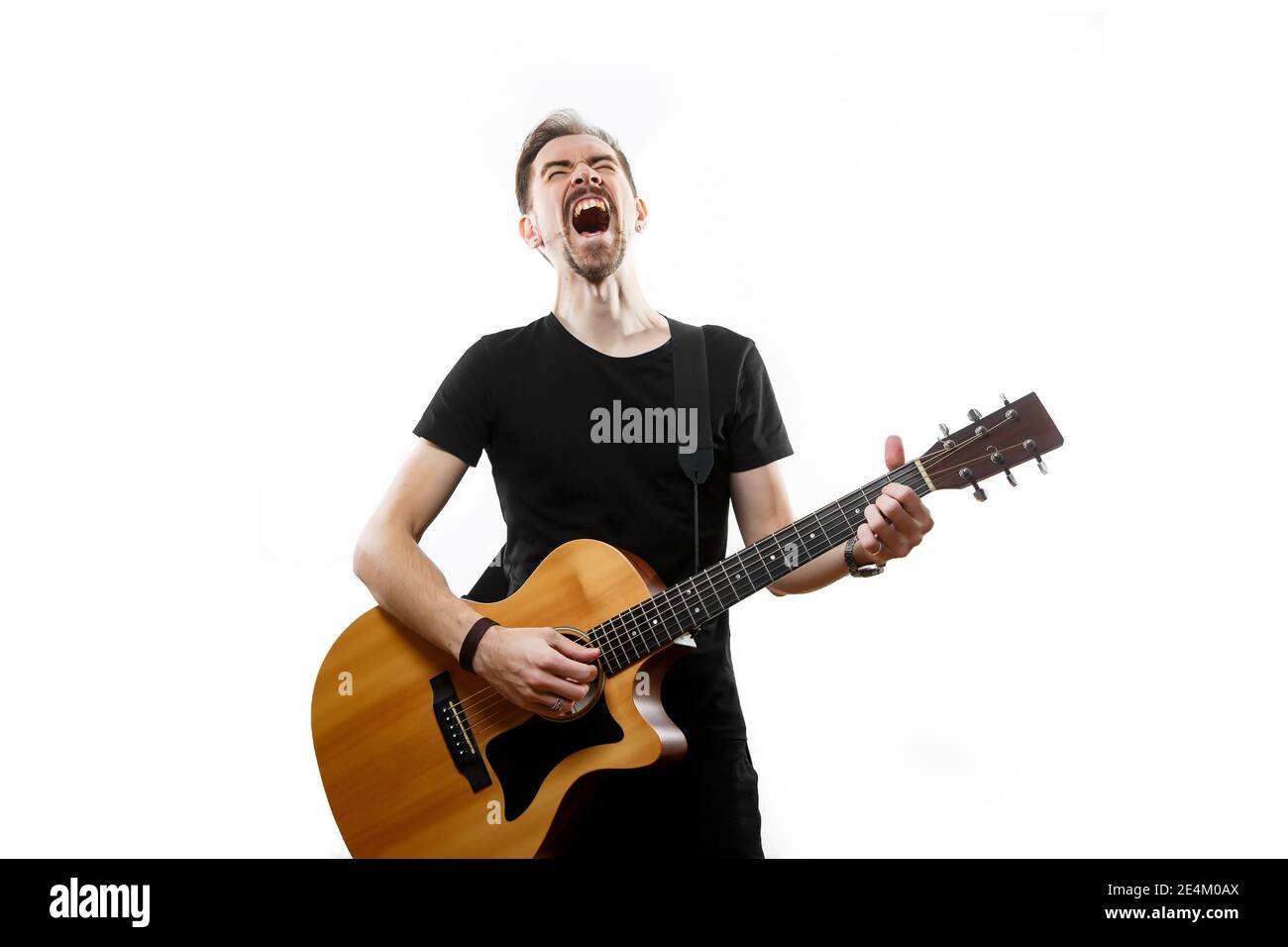 Guitarist playing and singing loudly on isolated a white background