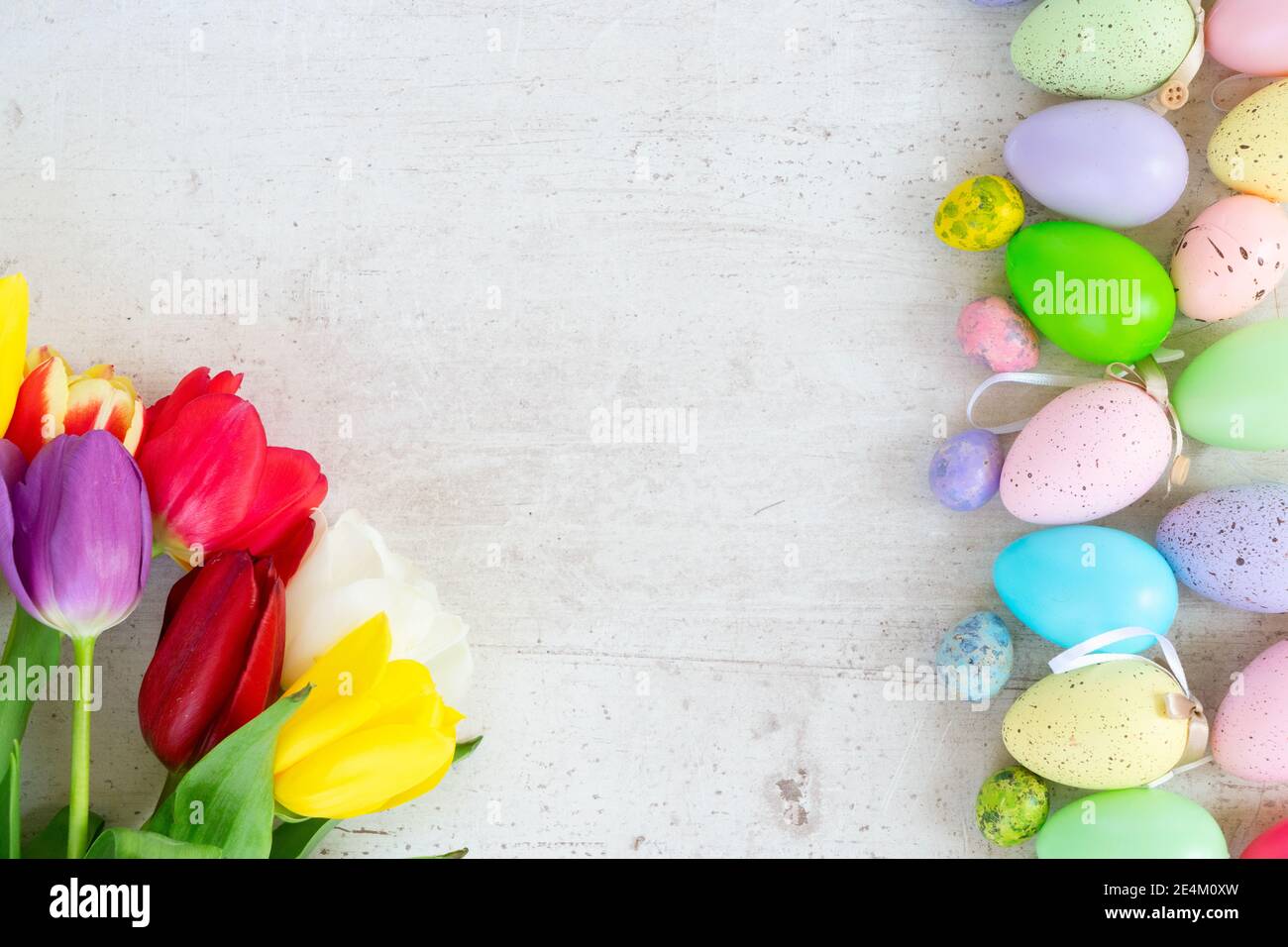 Easter colored eggs with tulips Stock Photo - Alamy