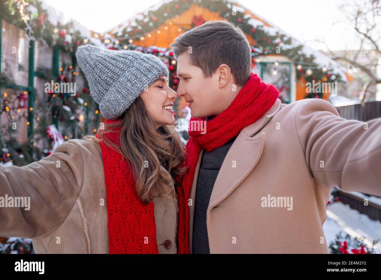 Joyful young couple bonding and taking selfie outdoors Stock Photo