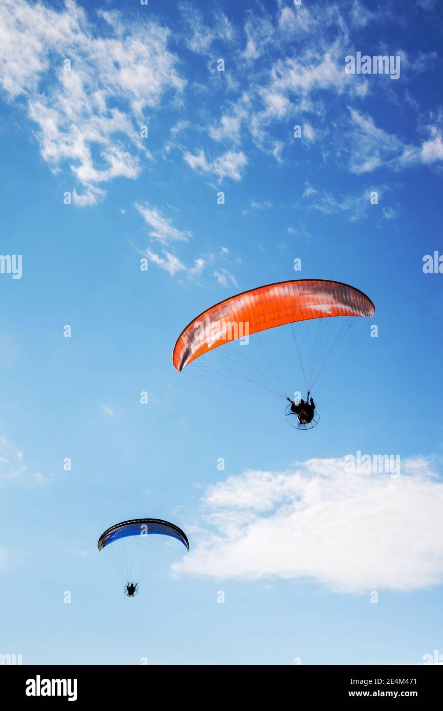 paratrooper parachute on sky. Flying with paramotor (paraglider) in the blue sky Stock Photo