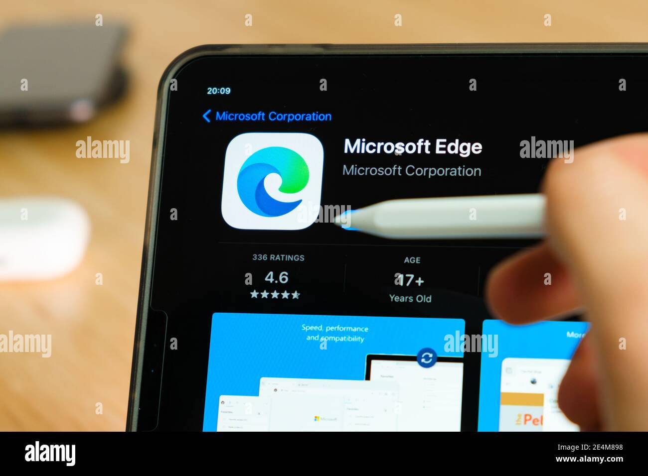 Microsoft Edge logo shown by apple pencil on the iPad Pro tablet screen. Man using application on the tablet. December 2020, San Francisco, USA. Stock Photo