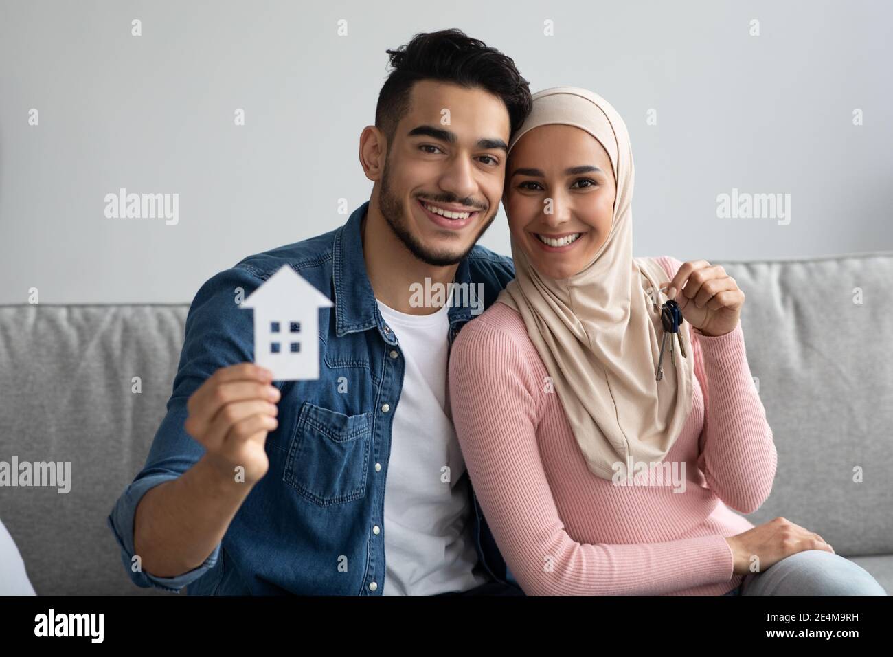 Young smiling muslim couple holding their new house keys Stock Photo ...