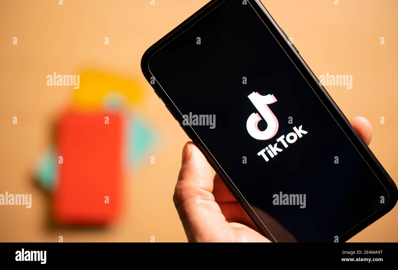 Rome, Italy, 24 January 2021. Overhead shot of a human hand holding a smartphone with the TikTok logo. Stock Photo