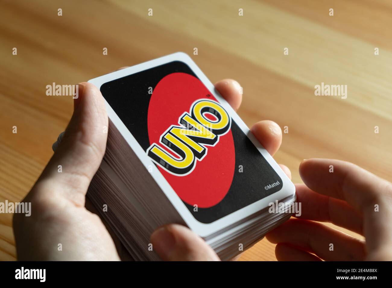 Bangkok, Thailand - January 23, 2021 : A man playing UNO card game. Stock Photo