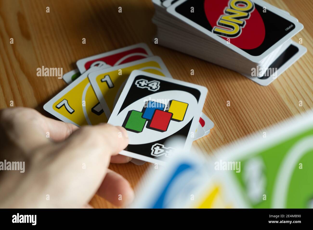 Bangkok, Thailand - January 23, 2021 : A man playing UNO card game. Stock Photo