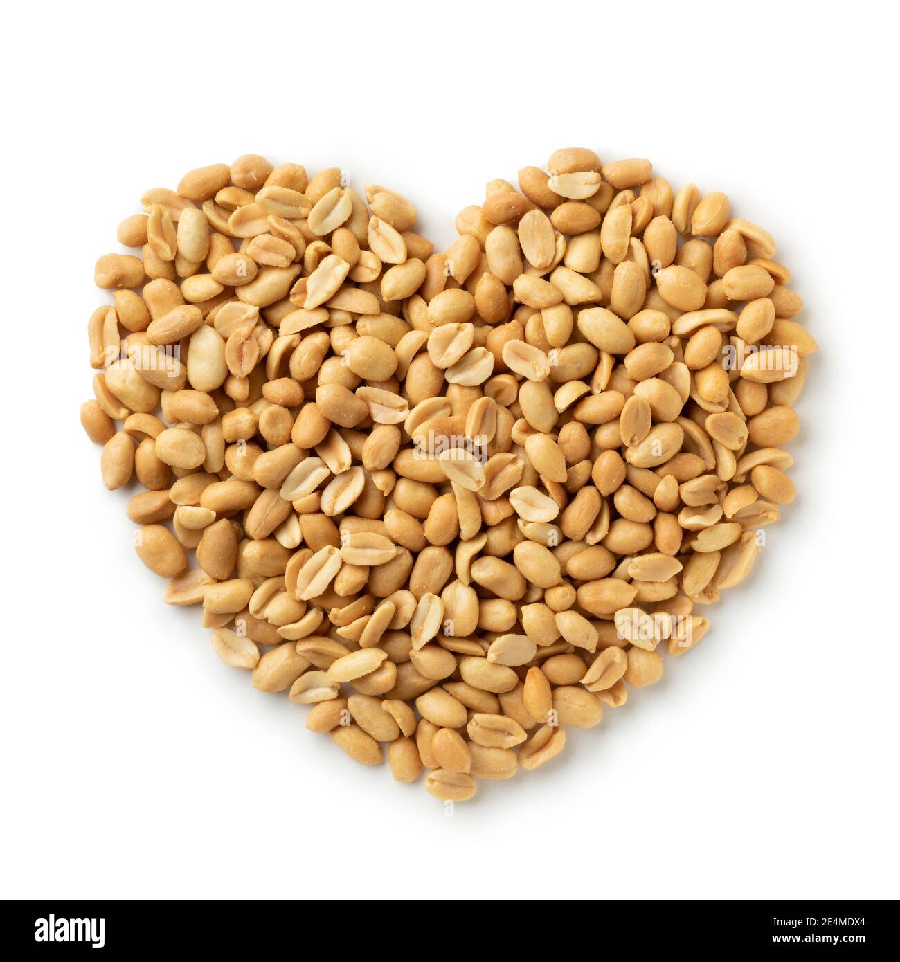 Salted peeled peanuts in a heart shape isolated on white background for a snack Stock Photo