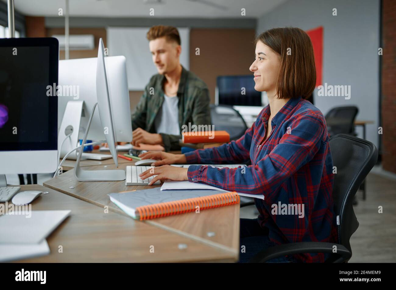 Two IT specialists works on computers in office Stock Photo