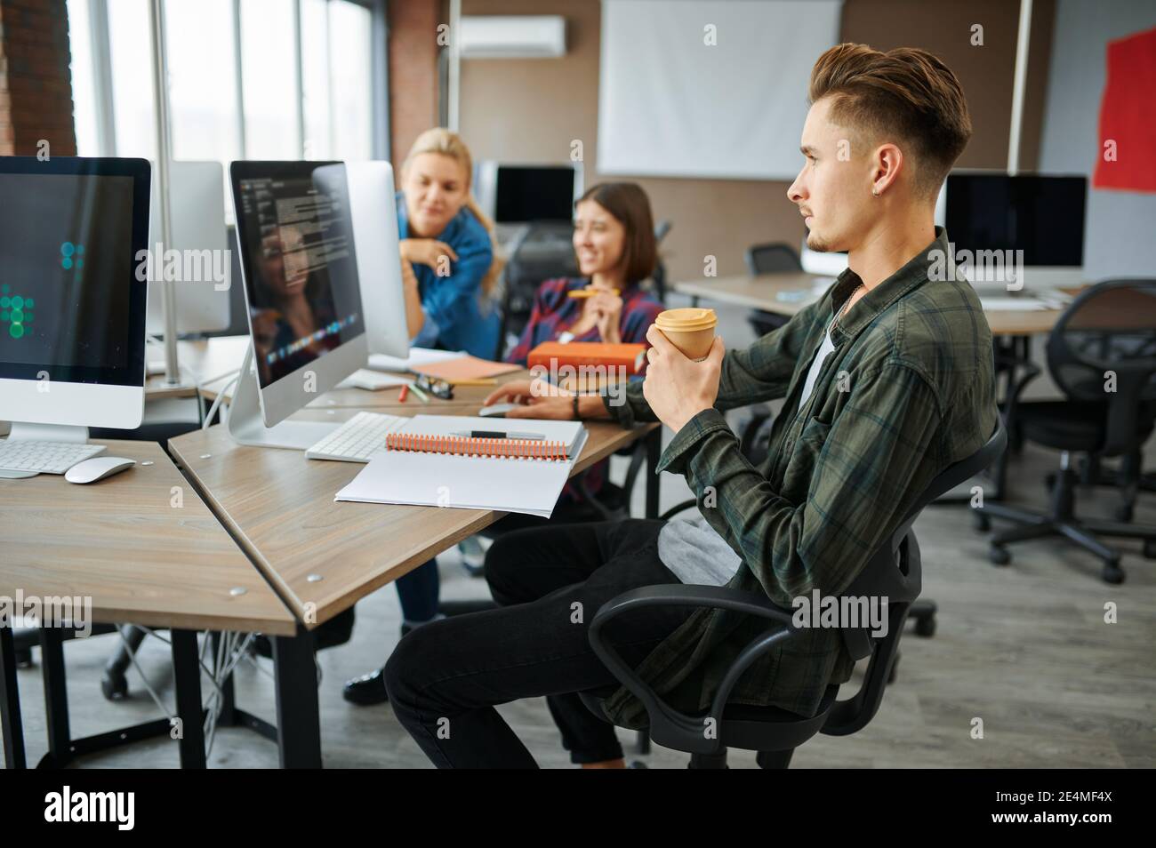 Young IT specialists works on computers in office Stock Photo