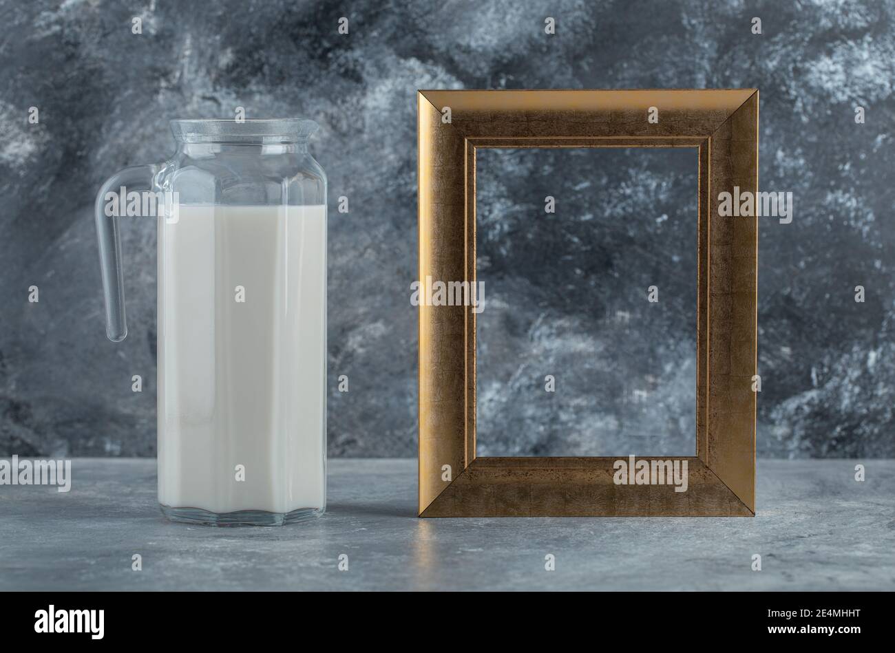 Jug of fresh milk and picture frame on marble background Stock Photo ...