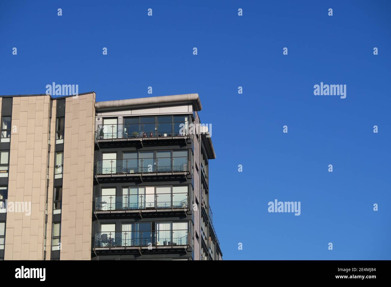 Close-up of a modern high rise residential building architecture detail with large window and balconies, Glasgow, Scotland Stock Photo