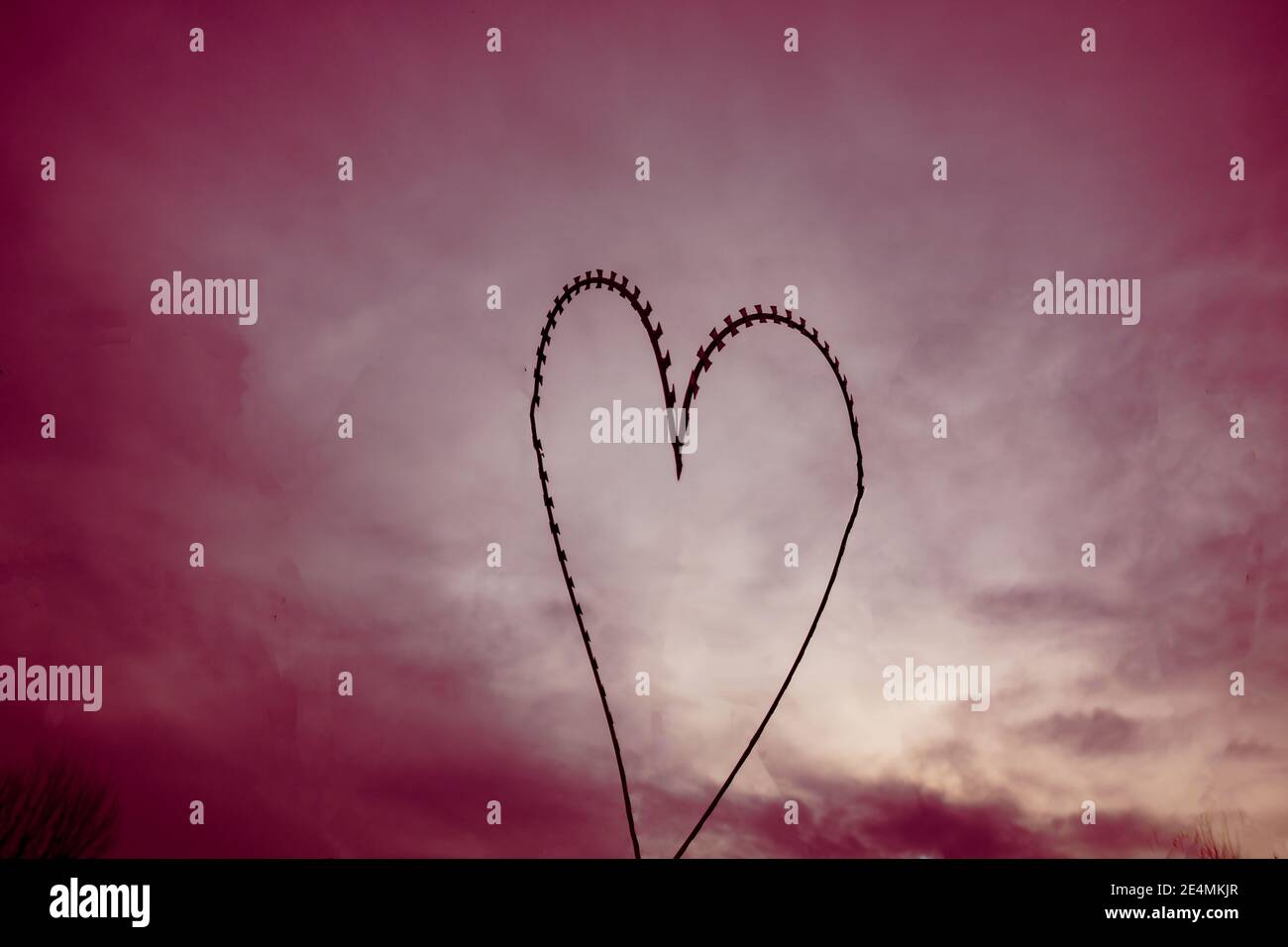 Heart shaped razor wire fences against the red sky Stock Photo - Alamy