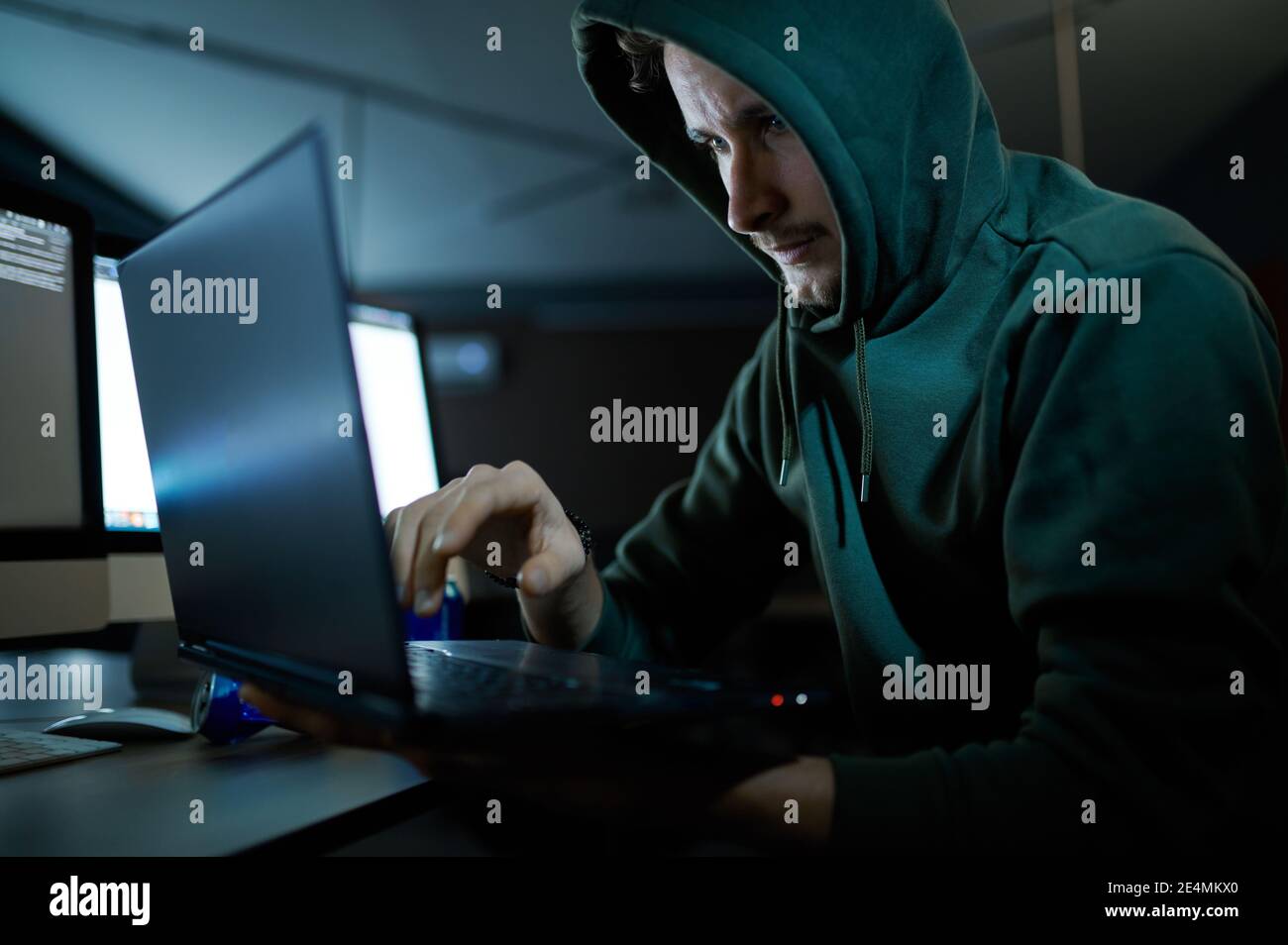 Hacker in black hood laptop hi-res stock photography and images - Alamy