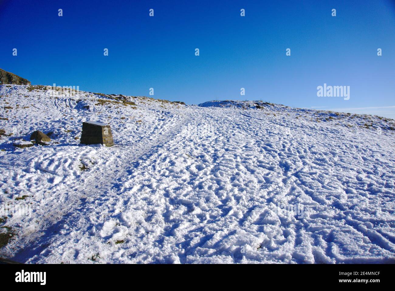 Path through the snow on a hillside near Hume village, Berwickshire, Scottish Borders, Scotland, UK. Stock Photo