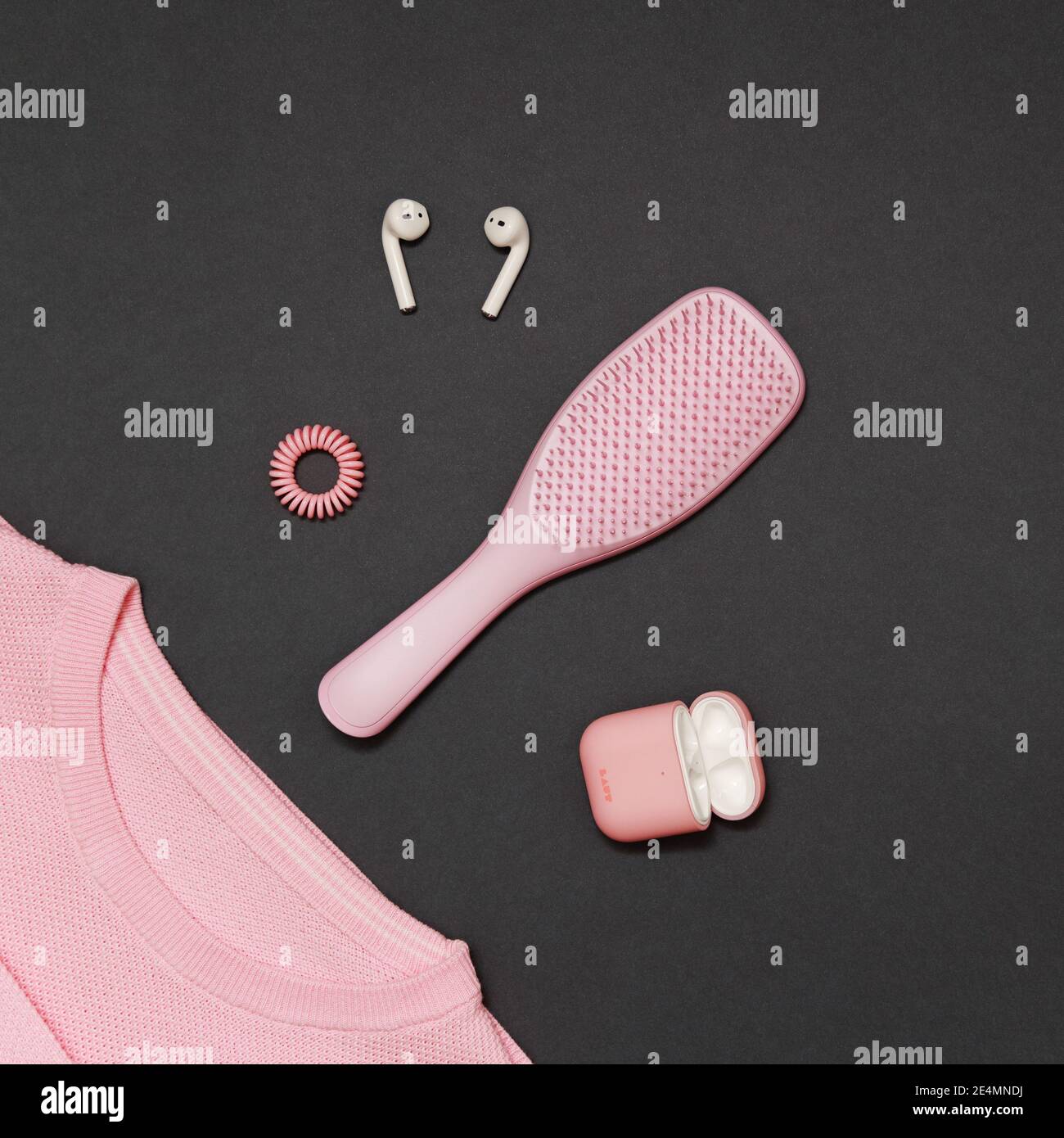 Odessa, Ukraine - December, 14 2020: A trendy light pink color girl's kit of Tangle Teezer hairbrush with Invisibobble hair ring, Apple AirPods with Stock Photo