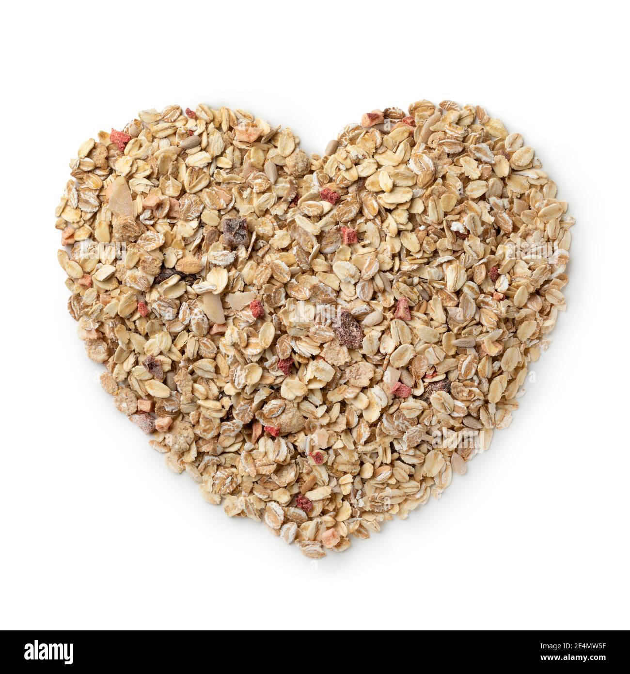 Heart shaped dried healthy muesli with dried fruit isolated on white background for beakfast on Valentines day Stock Photo