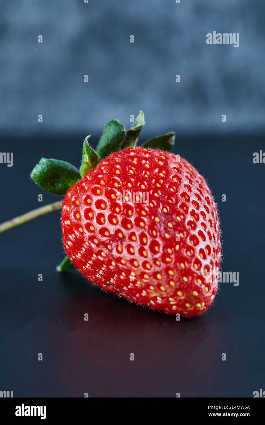 Fresh red strawberry on dark background. Close up Stock Photo - Alamy