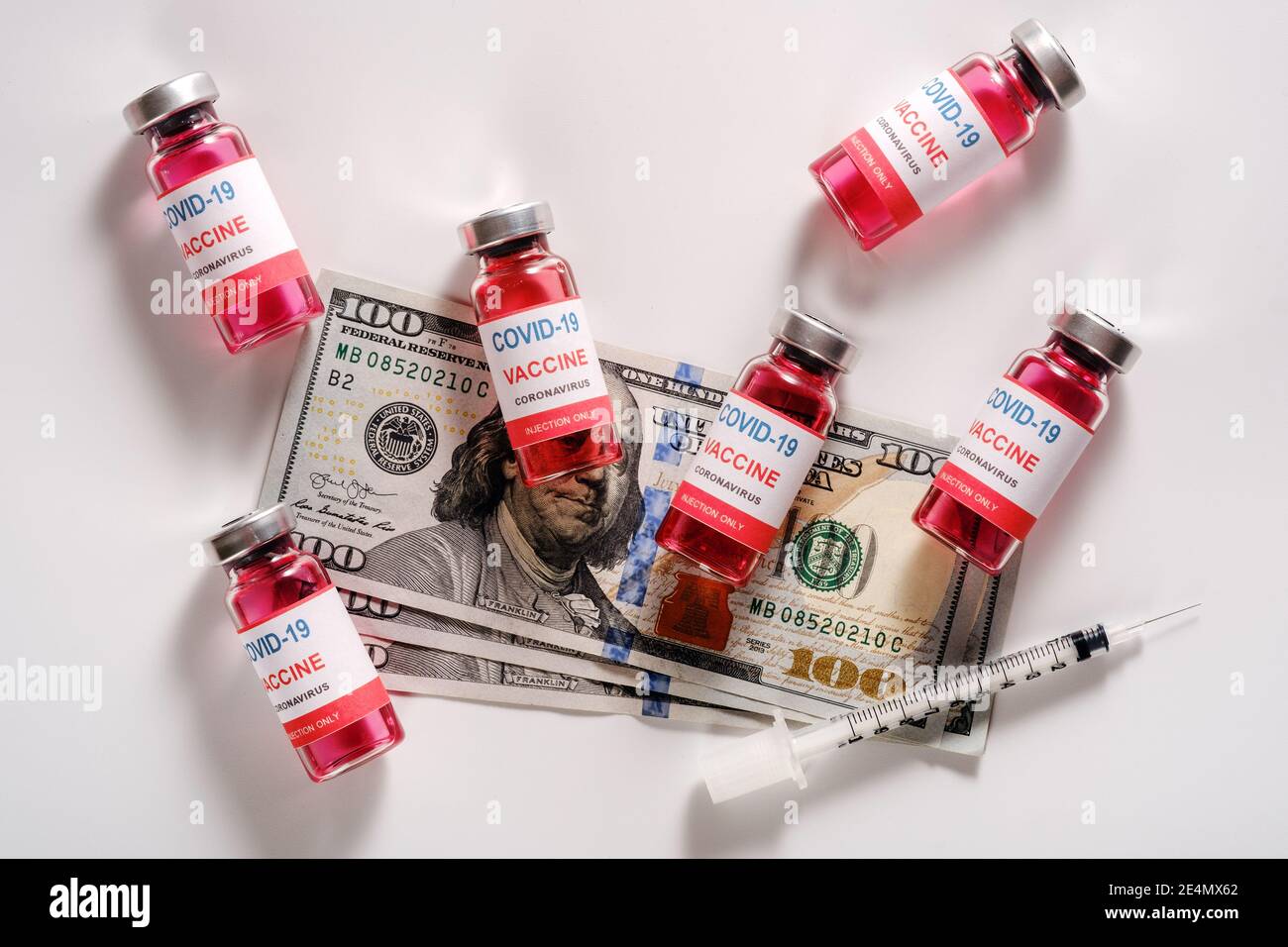 Money spent on COVID 19 vaccine and syringe Stock Photo