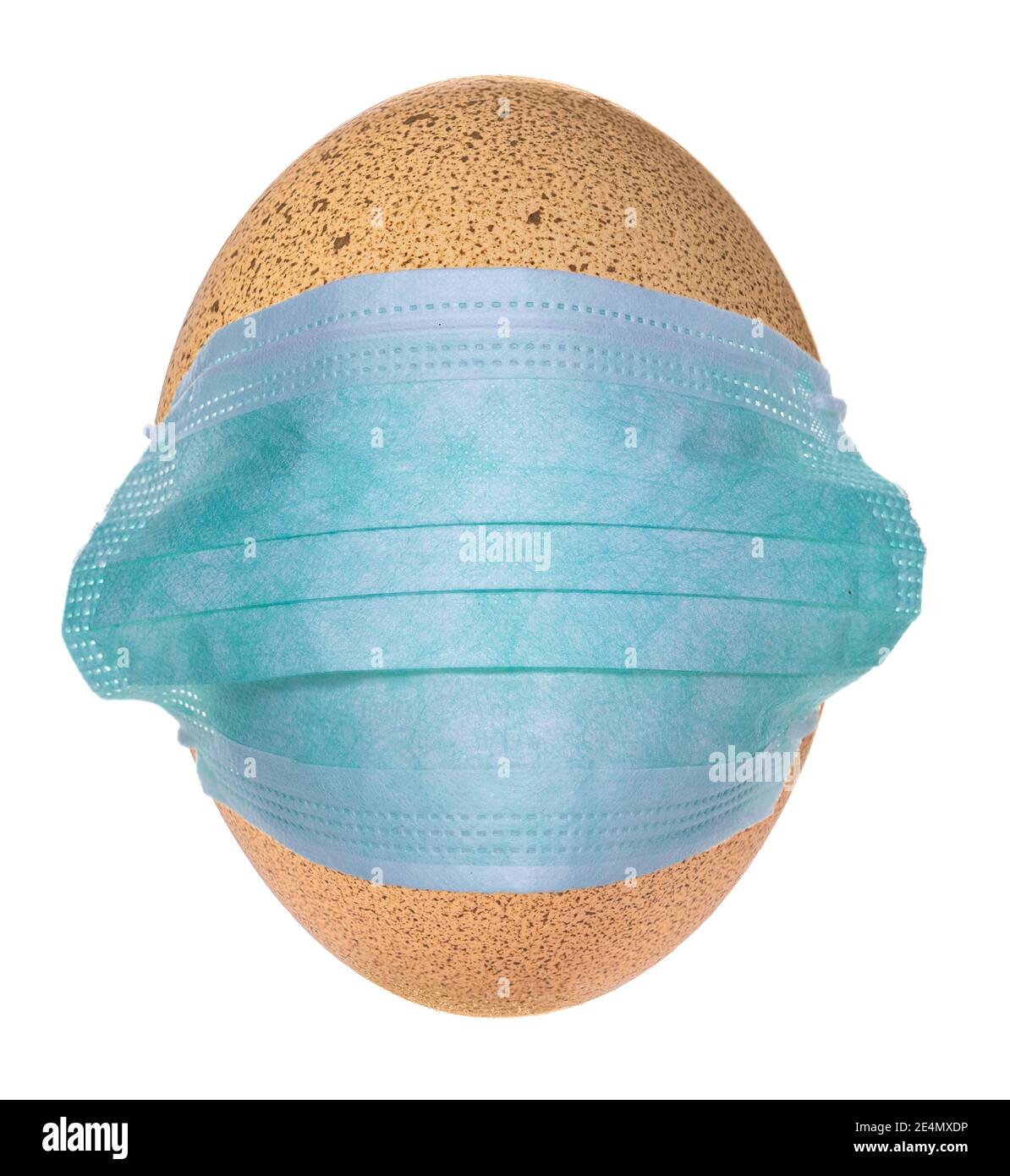 Virus protective, medical face mask put on a chicken egg. Stock Photo