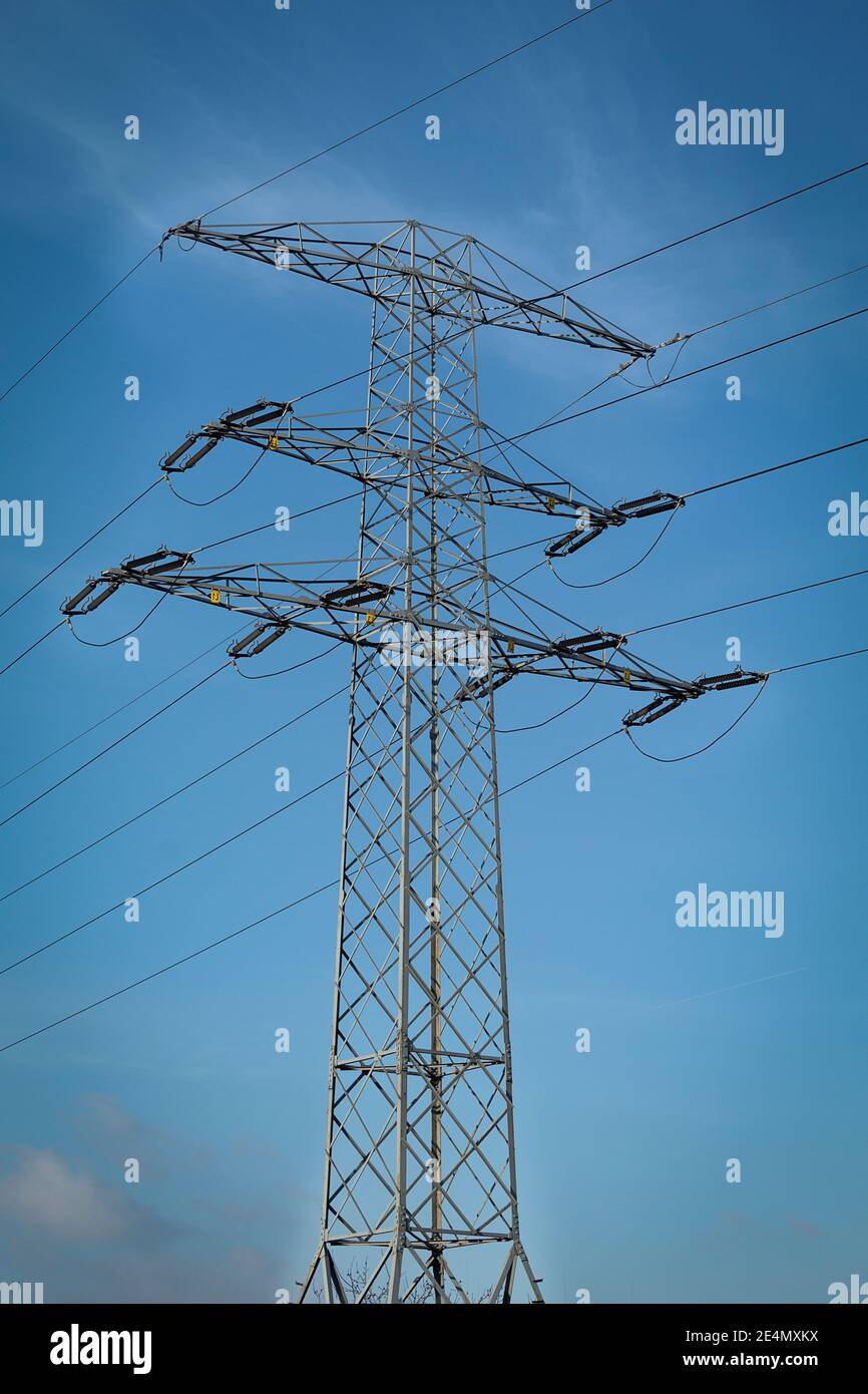 High voltage electrical wires on metal supports. High metal poles with ...