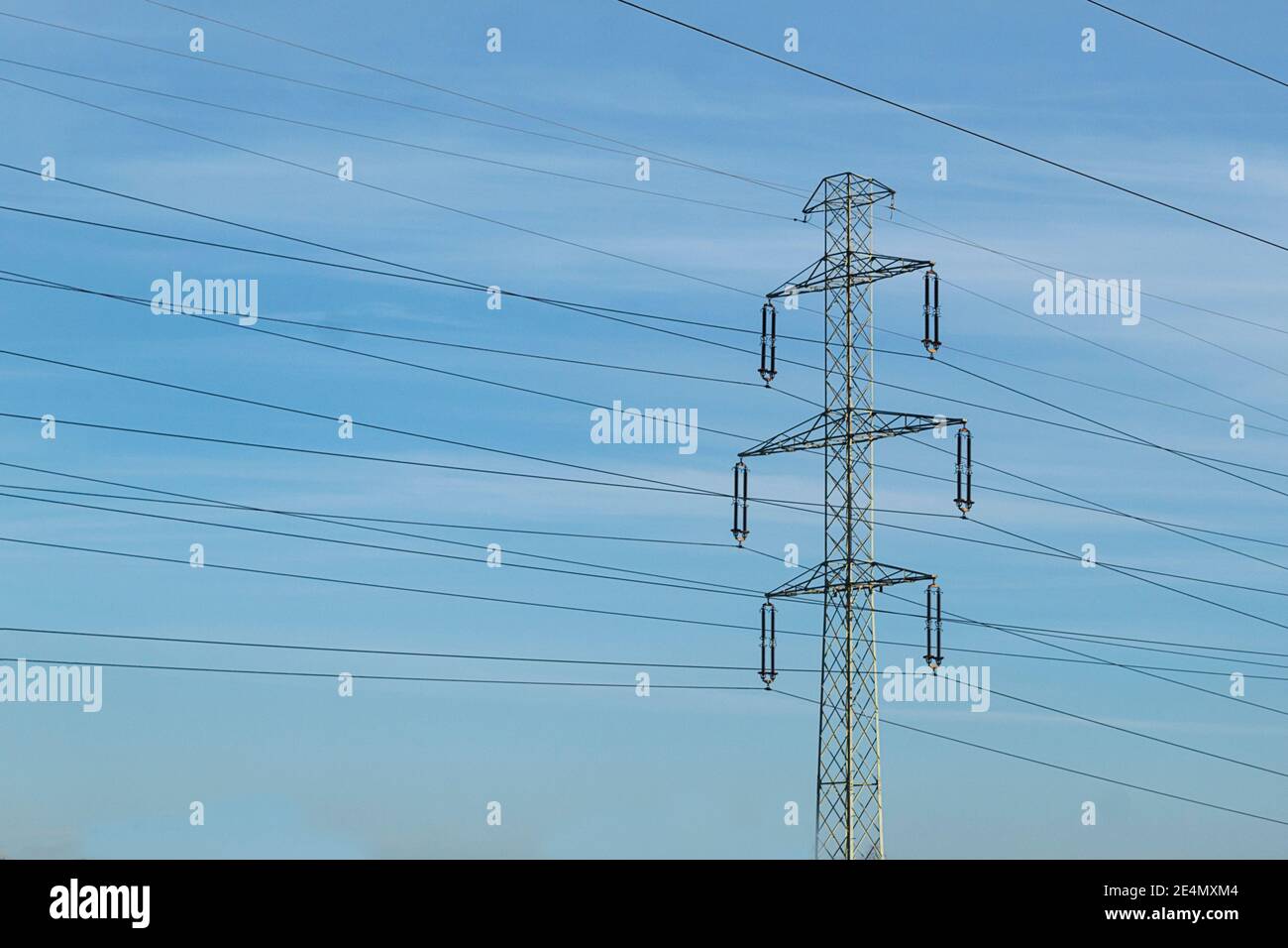 High voltage electrical wires on metal supports. High metal poles with ...