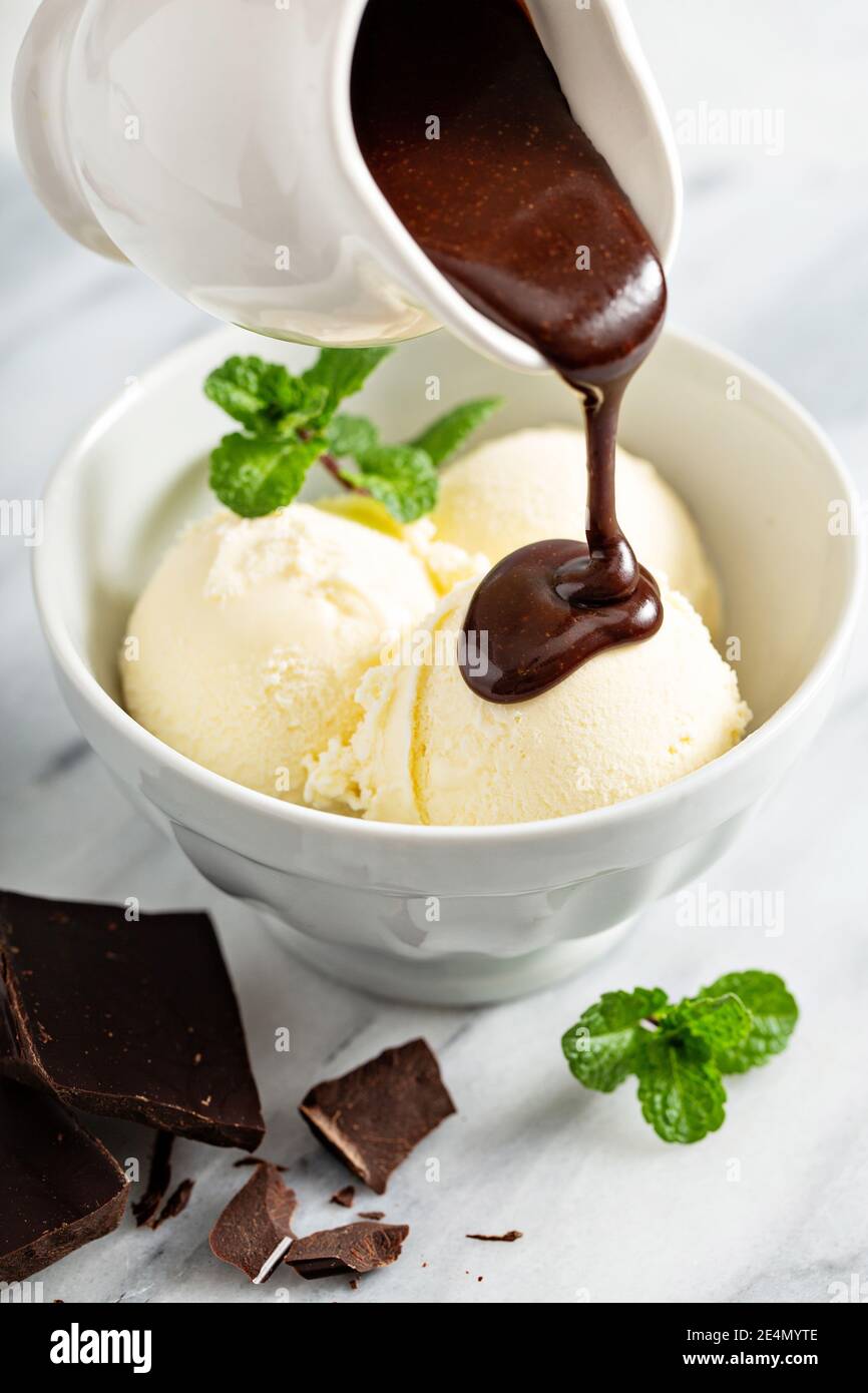Pouring chocolate sauce on ice cream Stock Photo Alamy