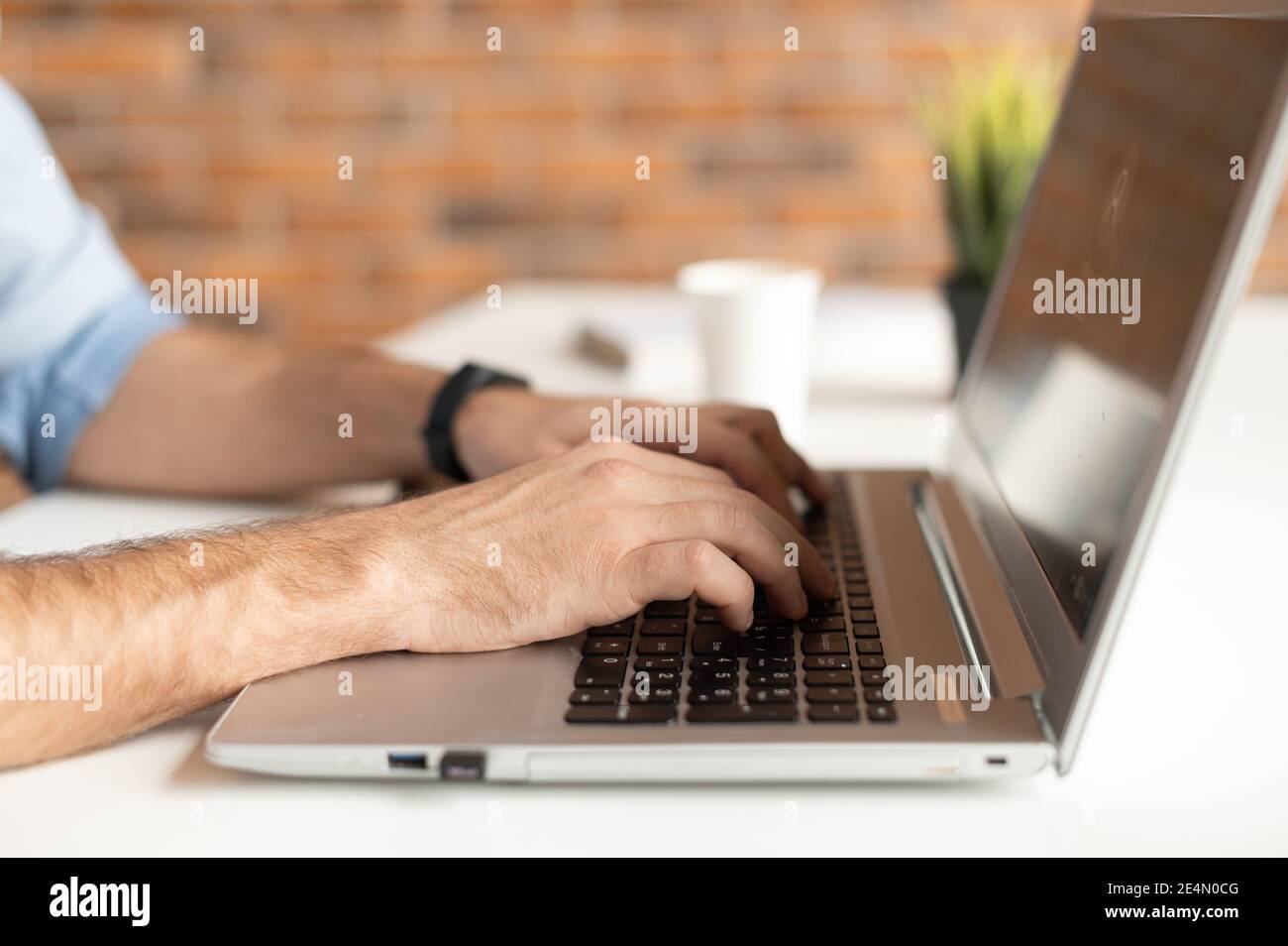 A male hands typing on the keyboard, unrecognizable face. Freelance developing software, a journalist is writing an article, chatting in a networks Stock Photo